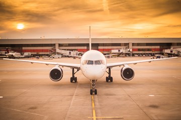 wide shot of white aeroplane at airport