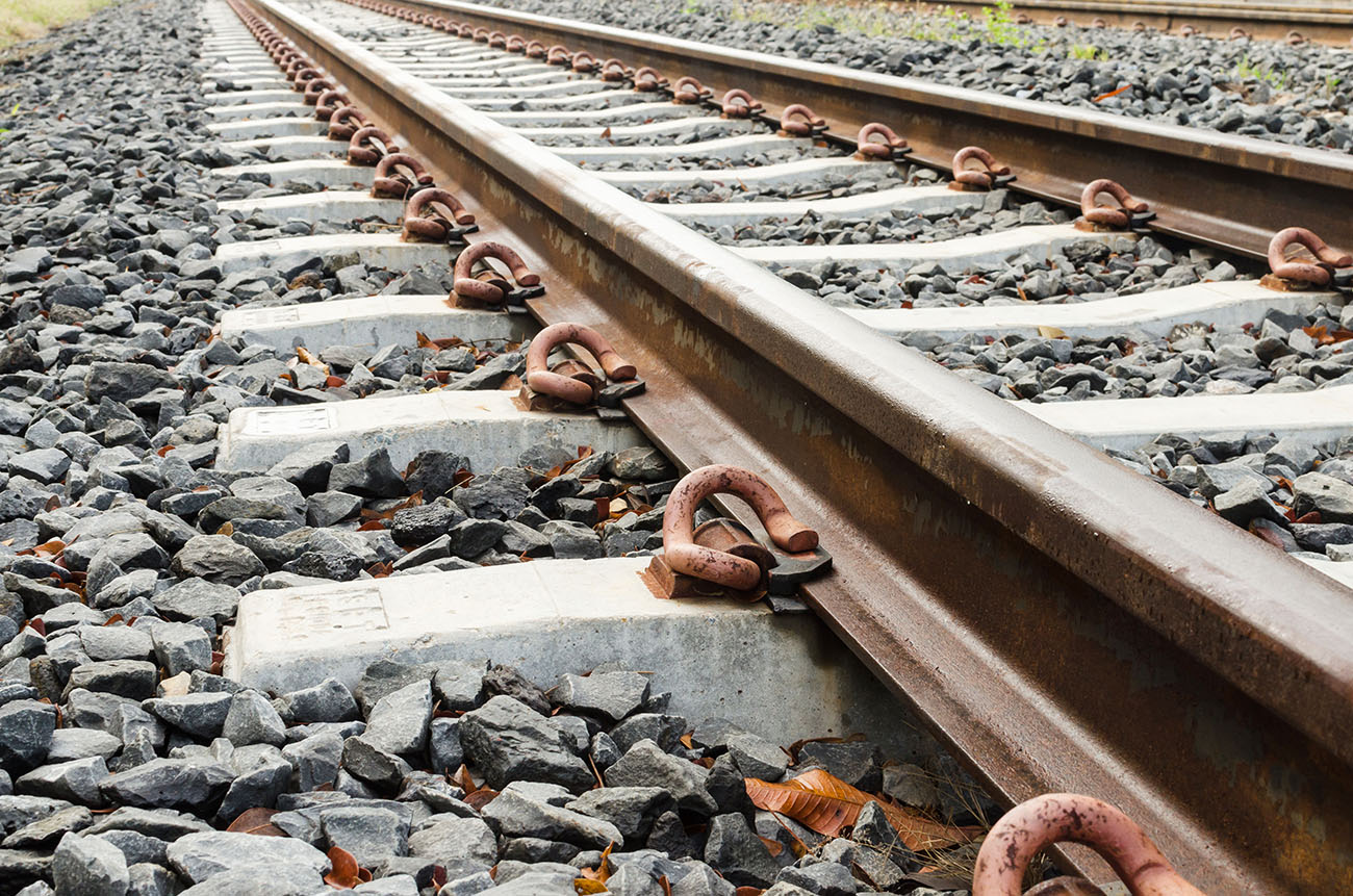 close up of train tracks and stones