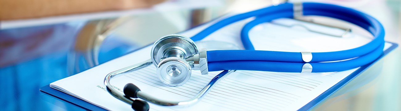 close up of stethoscope resting on a blue clipboard