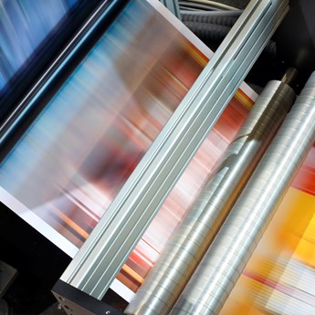 image of blurred coloured paper running through a machine