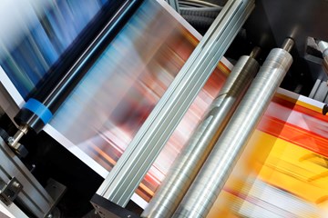 image of blurred coloured paper running through a machine