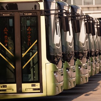 a row of buses all facing right