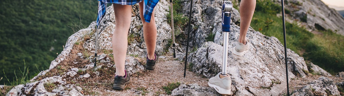 Amputee walking up a mountain