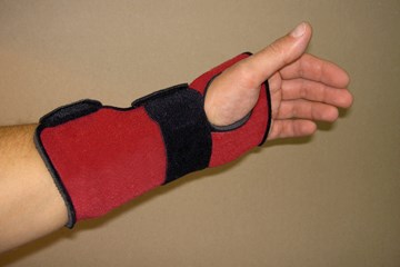 extended fore arm with red and black wrist support